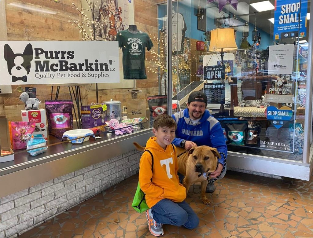 a man with a son and an adopted dog