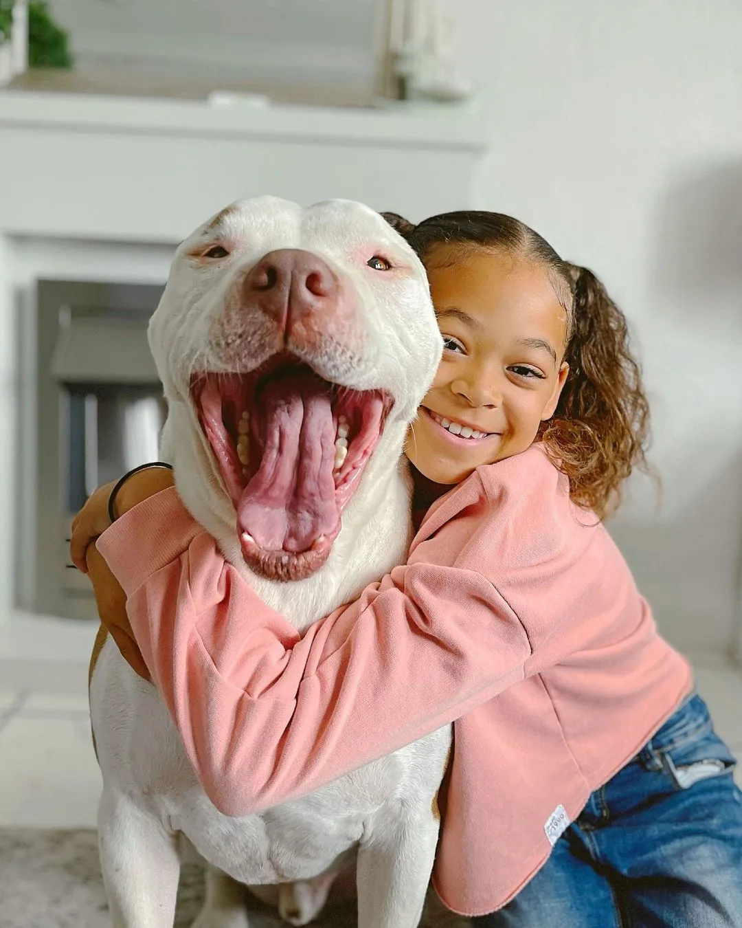 little girl hugging the dog