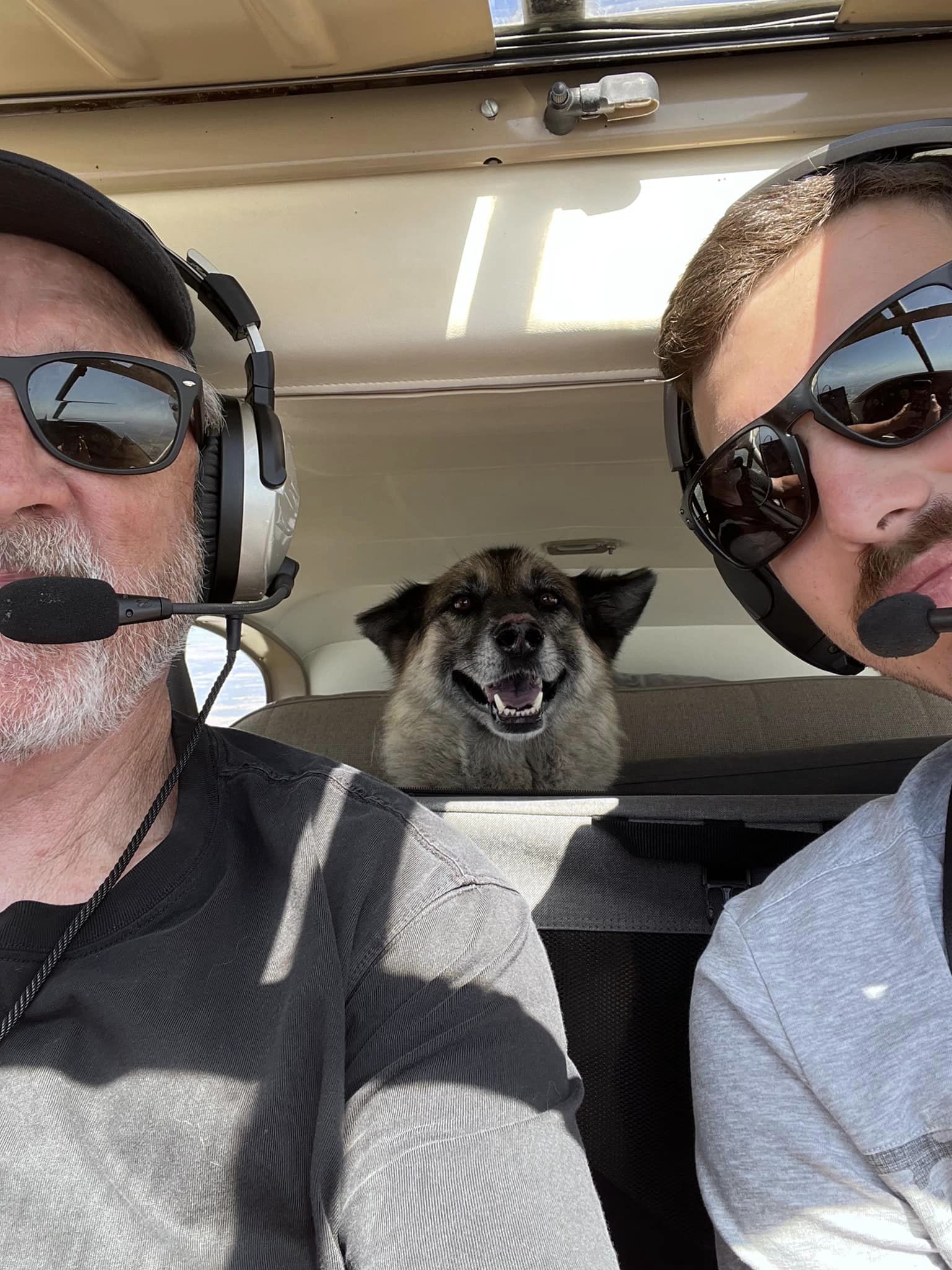 photo of dog named sheba and two pilots