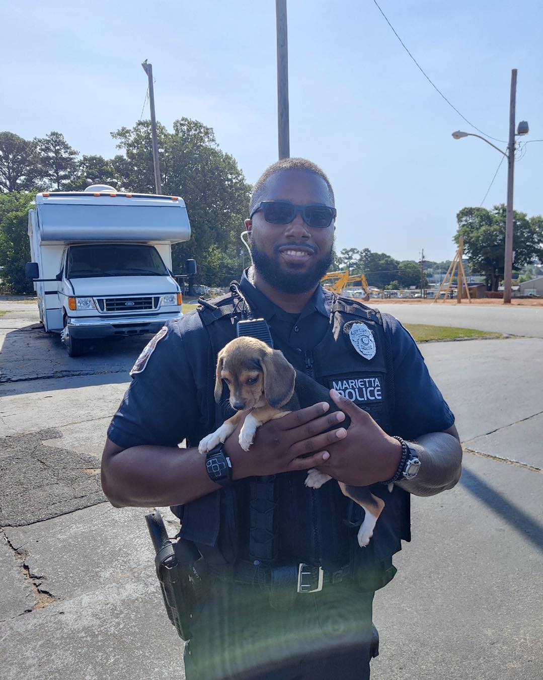police officer holding one of the runaway puppies