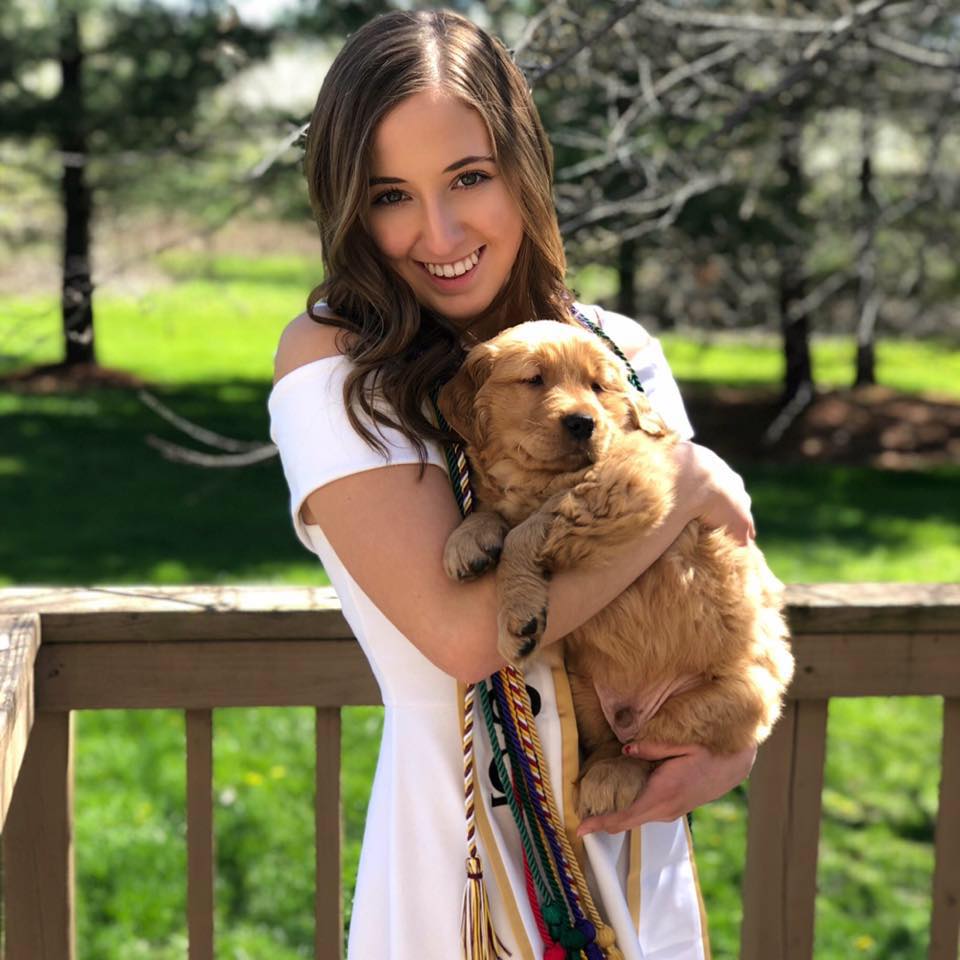 beautiful girl holding her dog