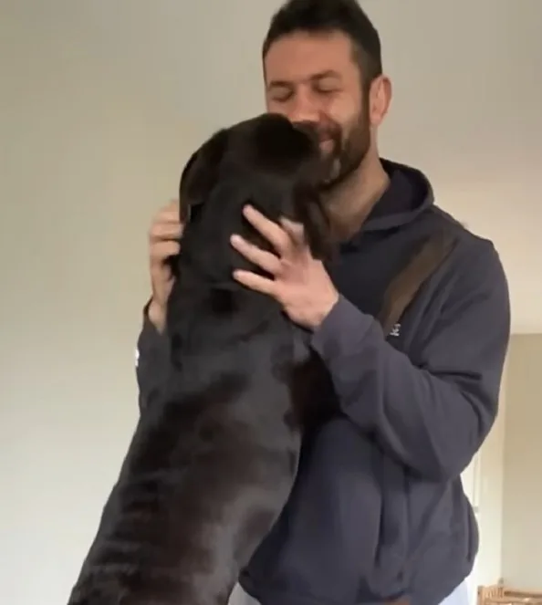 guy holding his dog