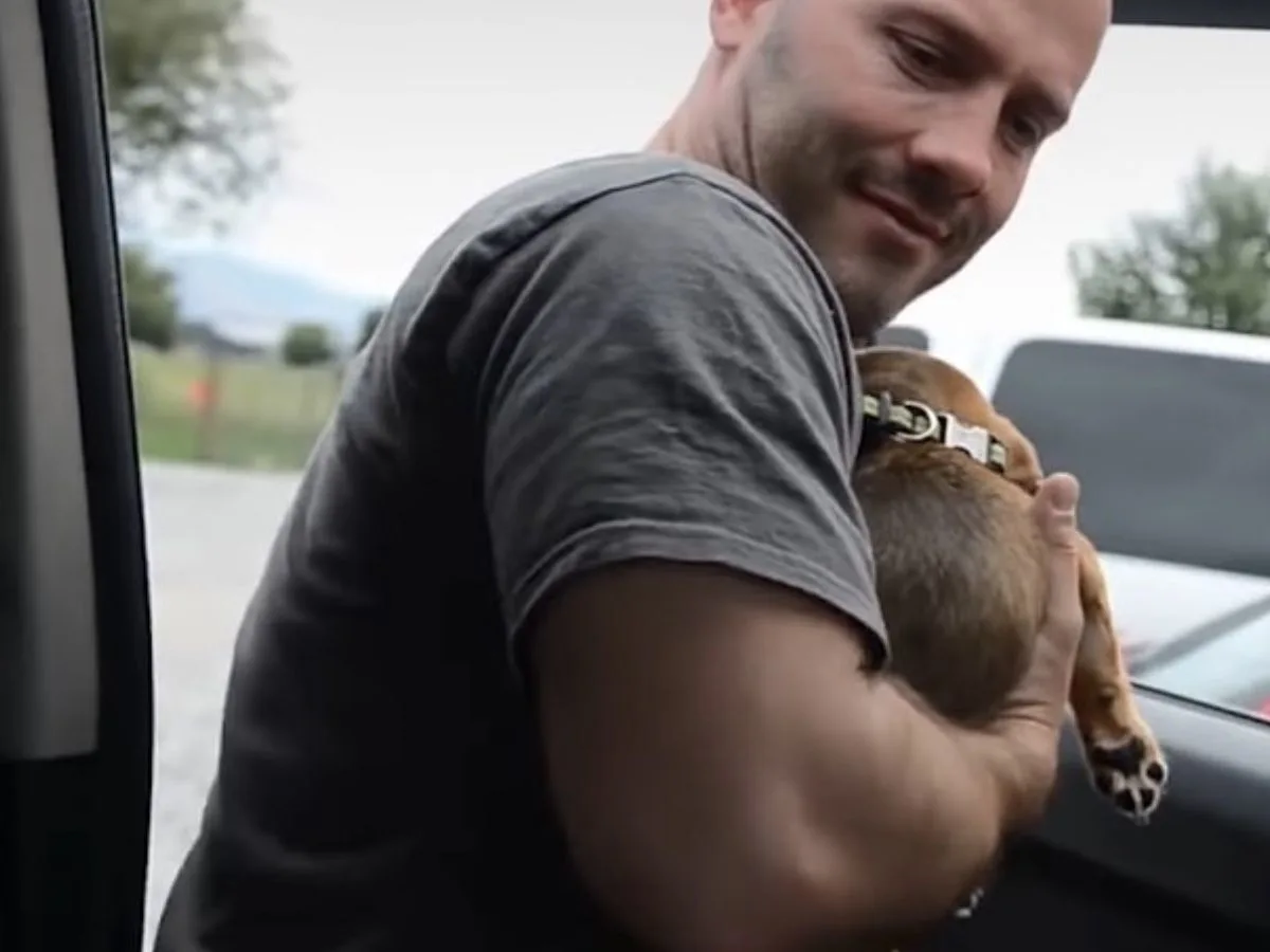 man holding a puppy