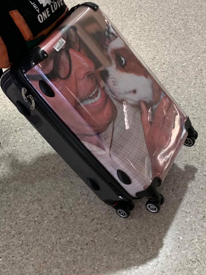 suitcase with a photo of man and dog