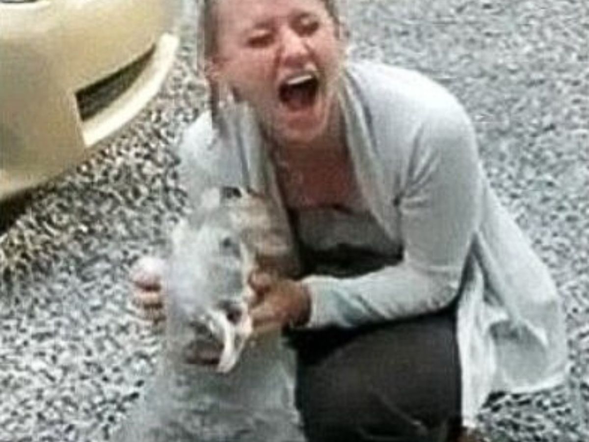 woman screaming while holding the dog