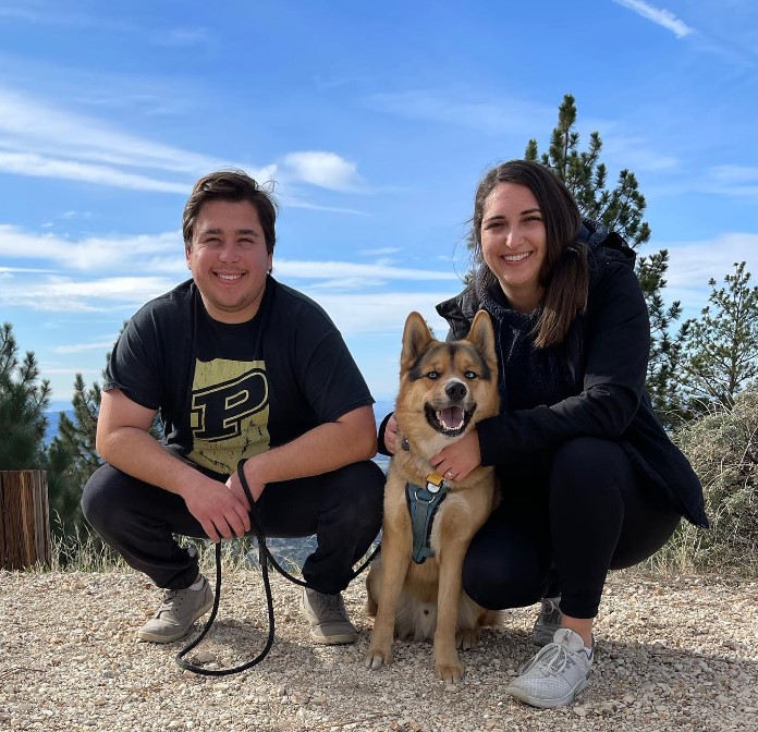 a man and a woman hugged a dog