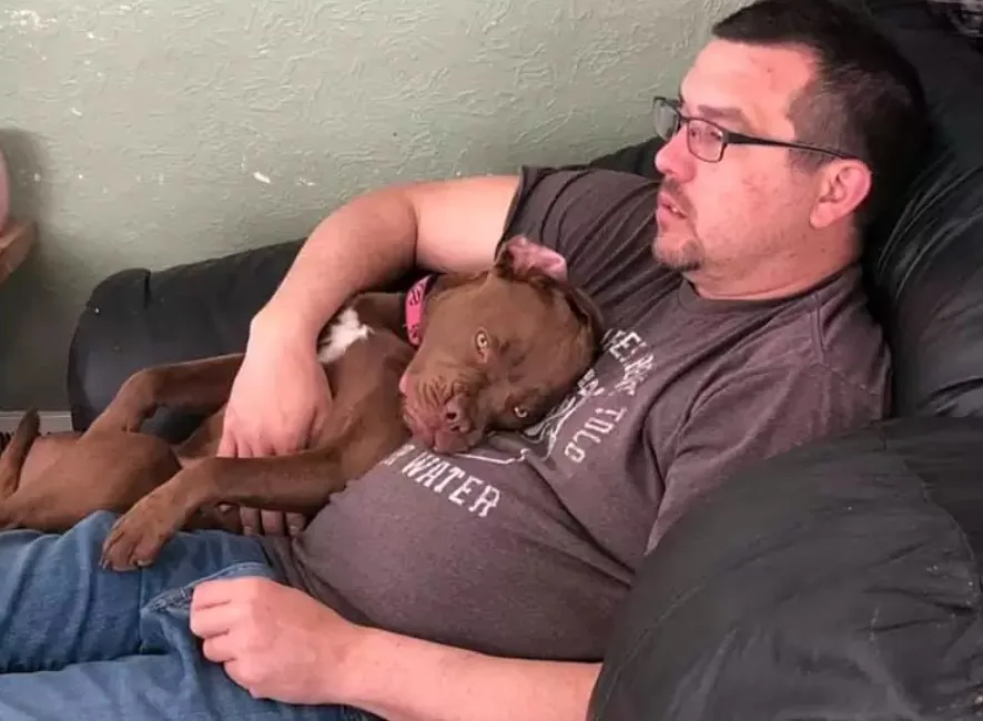 dog sleeping next to a man
