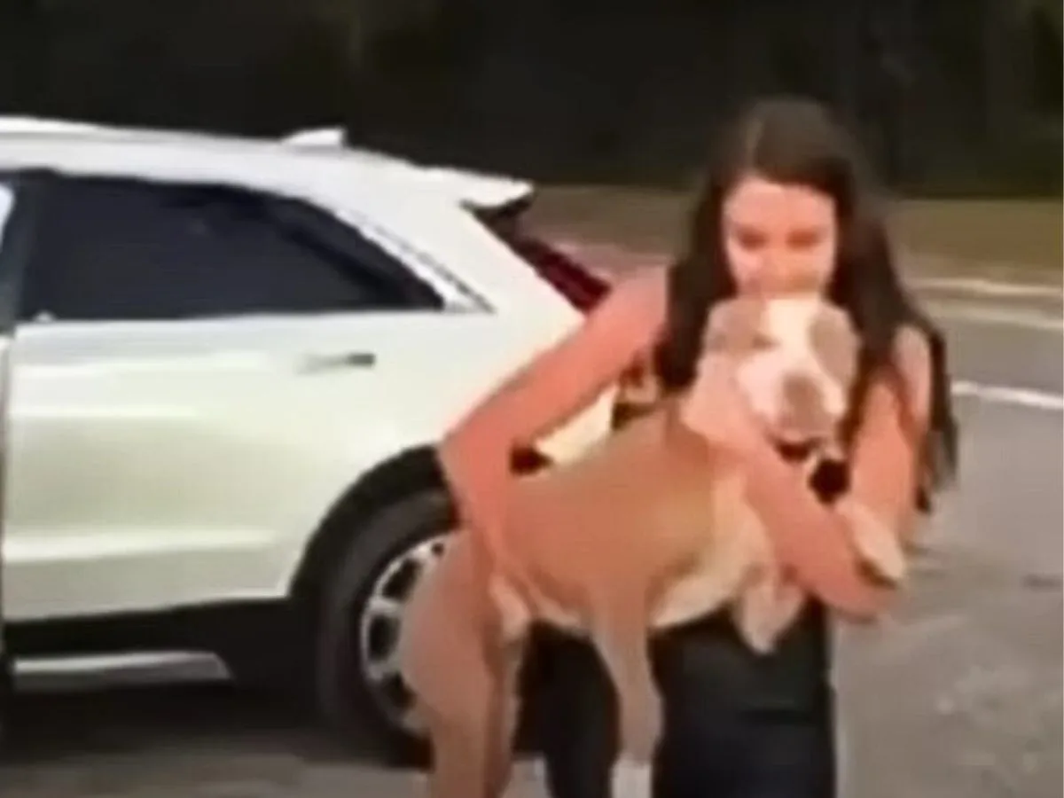 girl holding a dog