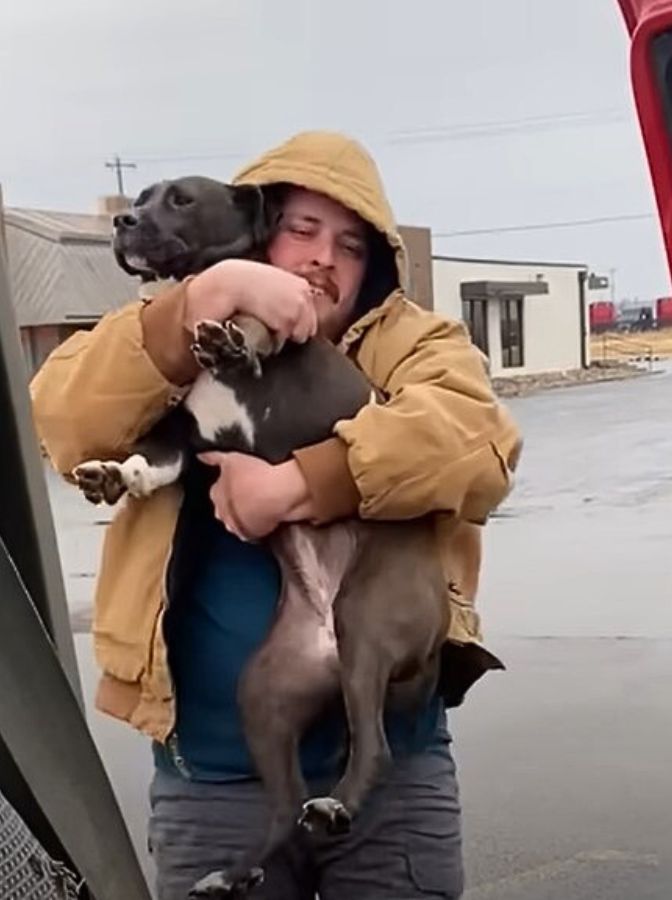 happy man carrying a dog