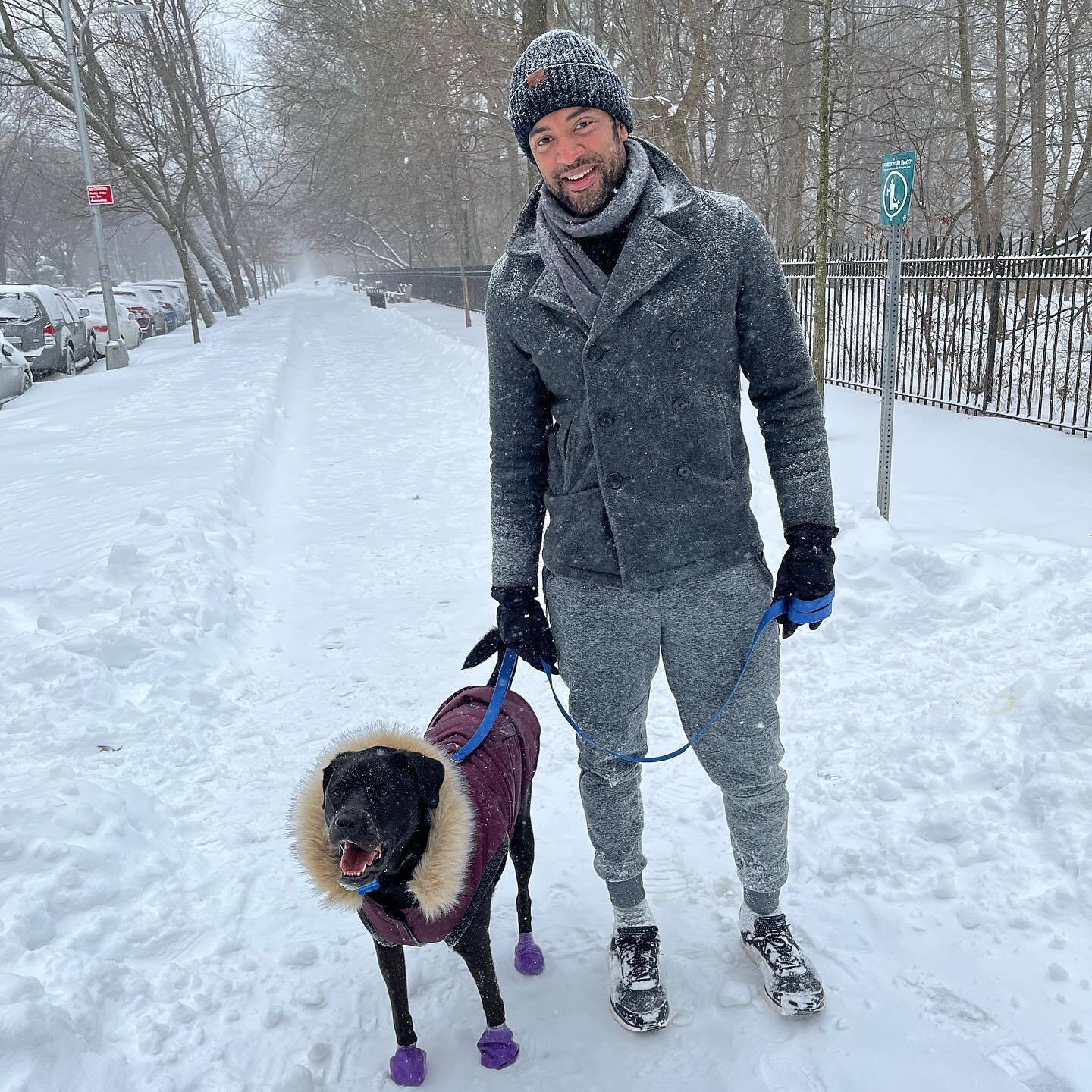 man-walking-with-dog-on-the-snow