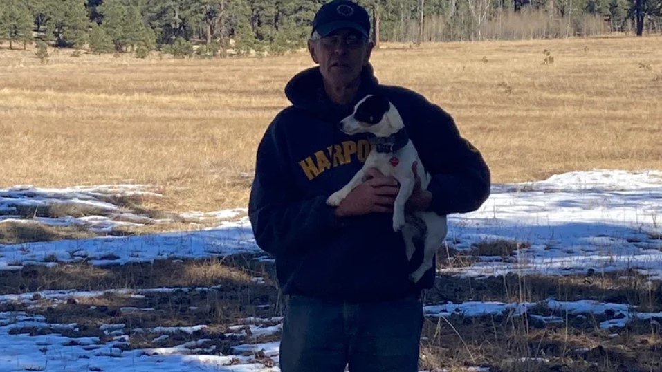 old guy holding a dog