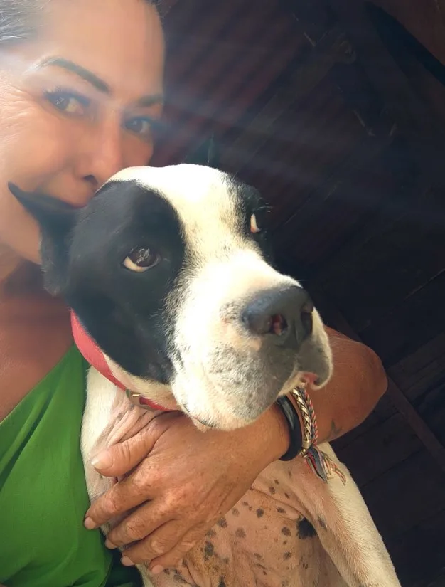 portrait of a girl hugging her dog