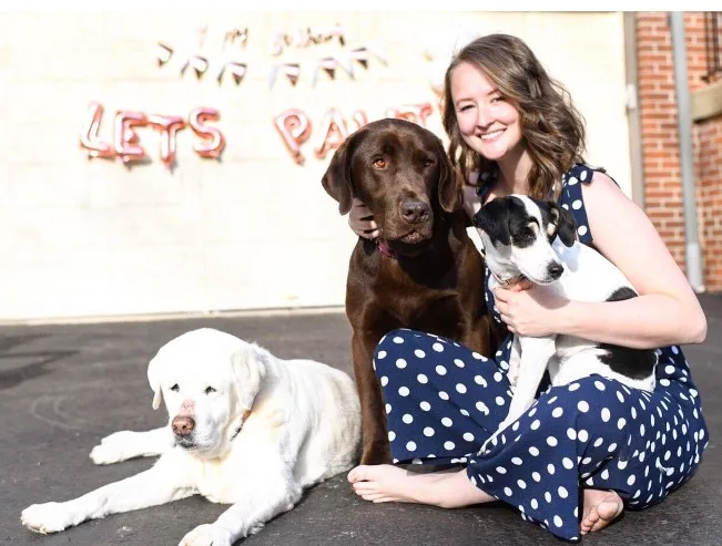 portrait of a girl with her three dogs