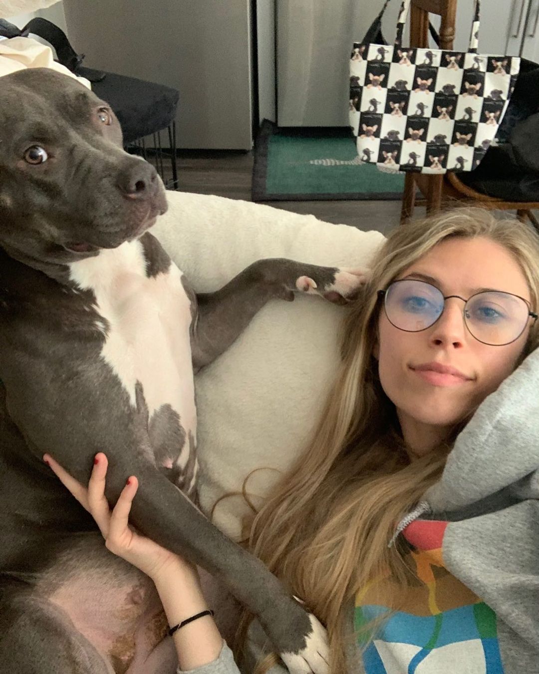 dog and woman lying on couch