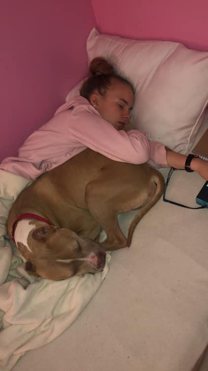 young girl sleeping with dog