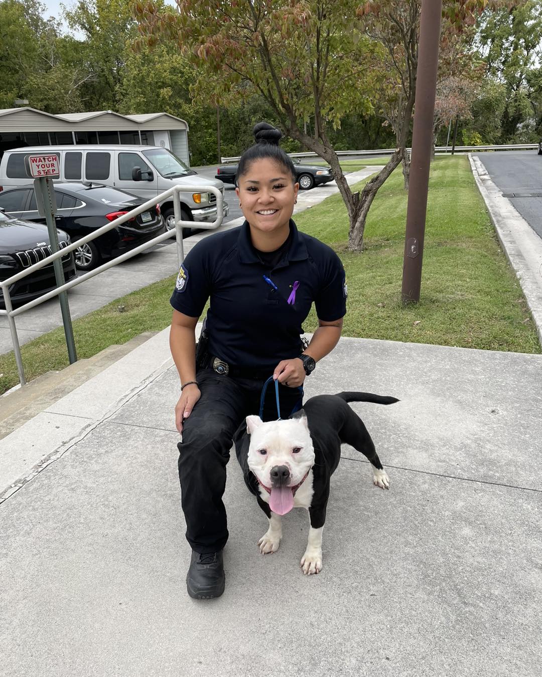 Policewoman holding dog on a leash