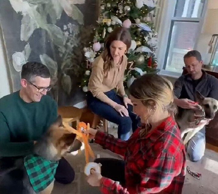 family with dog by christmas tree