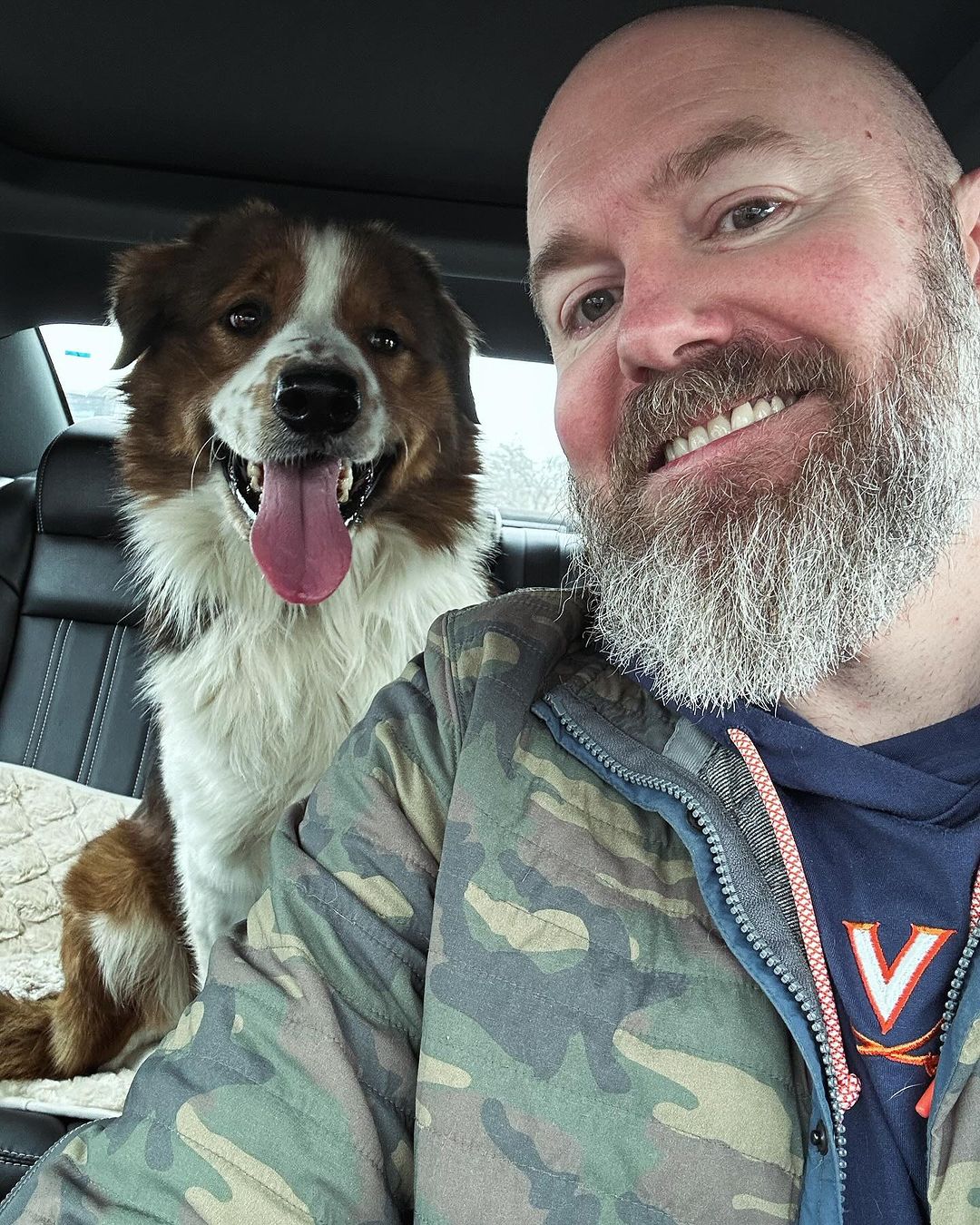 guy and his dog sitting in the car