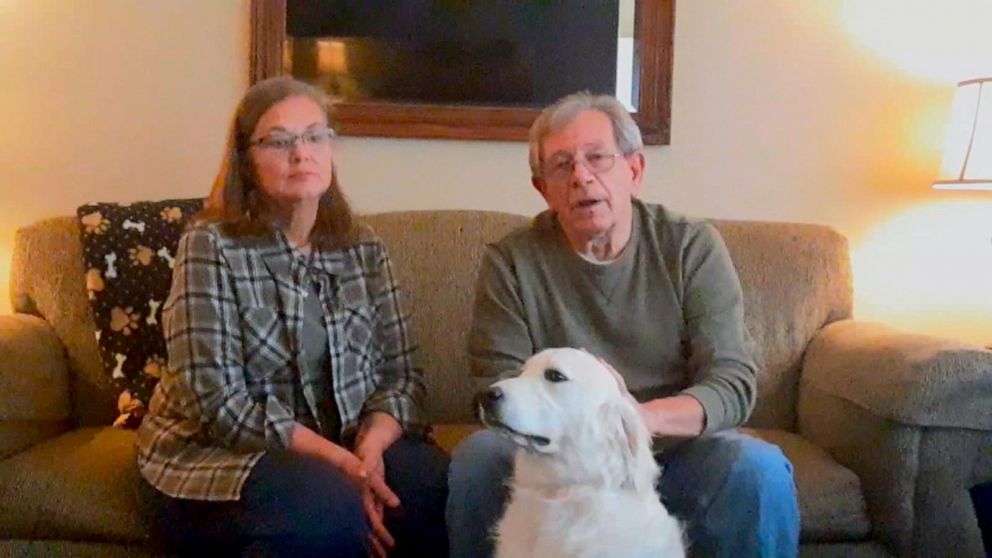 old couple and white dog