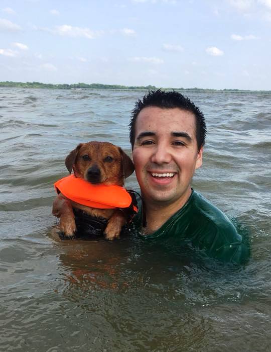 owner and dog swimming together