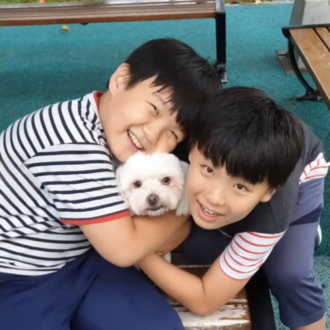 two little boys posing with dog