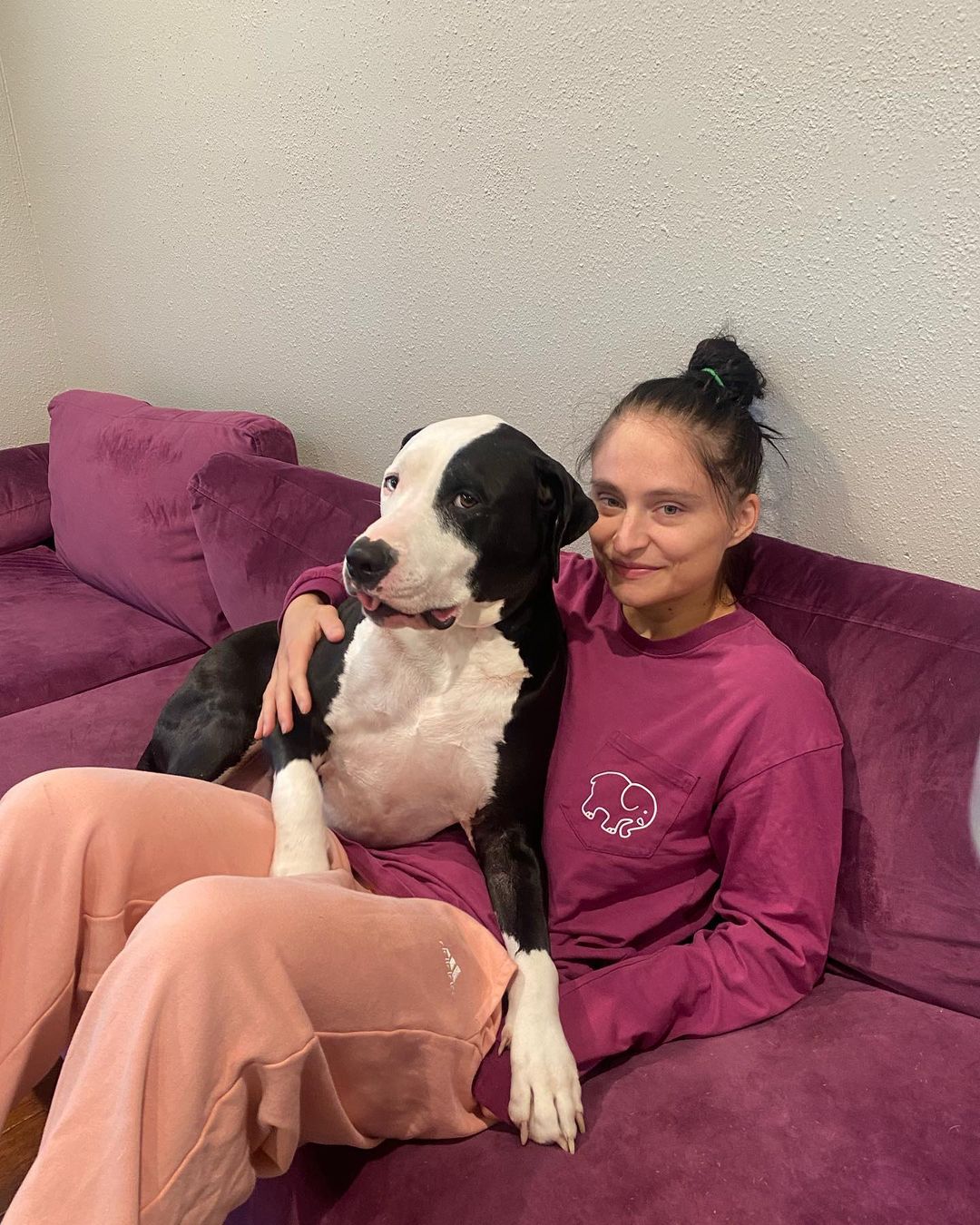 woman and adopted dog sitting on couch
