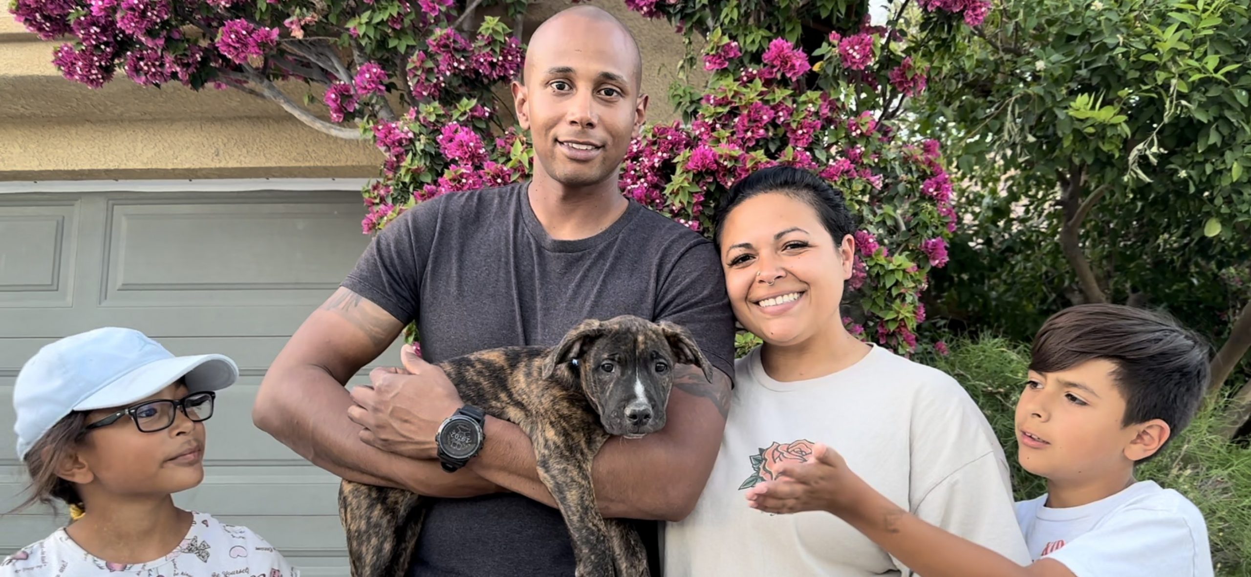 family and black puppy