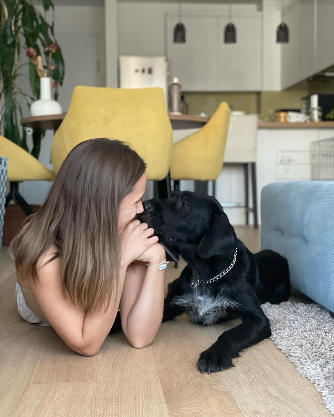 woman and dog lying on floor