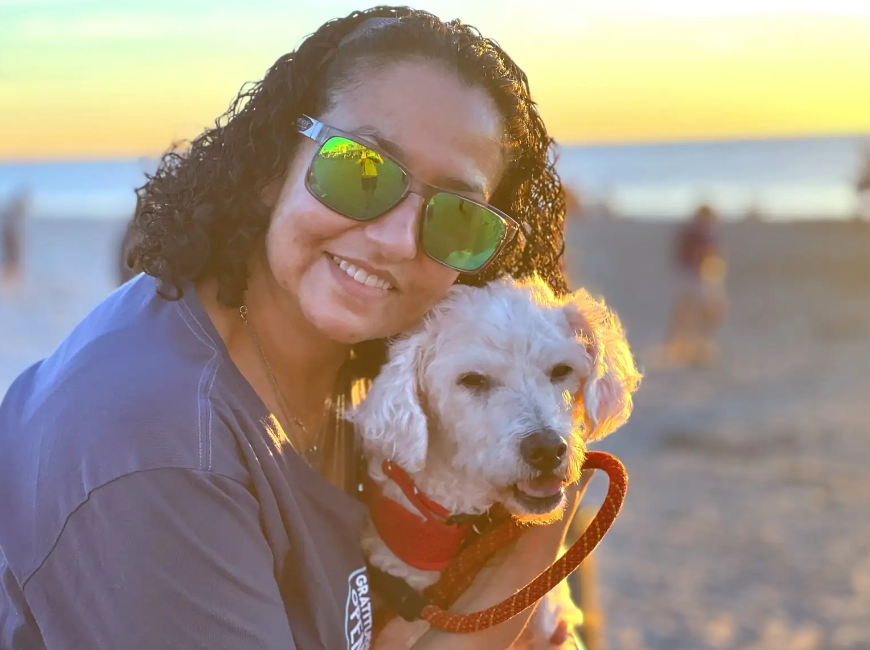 woman with sunglasses posing with dog