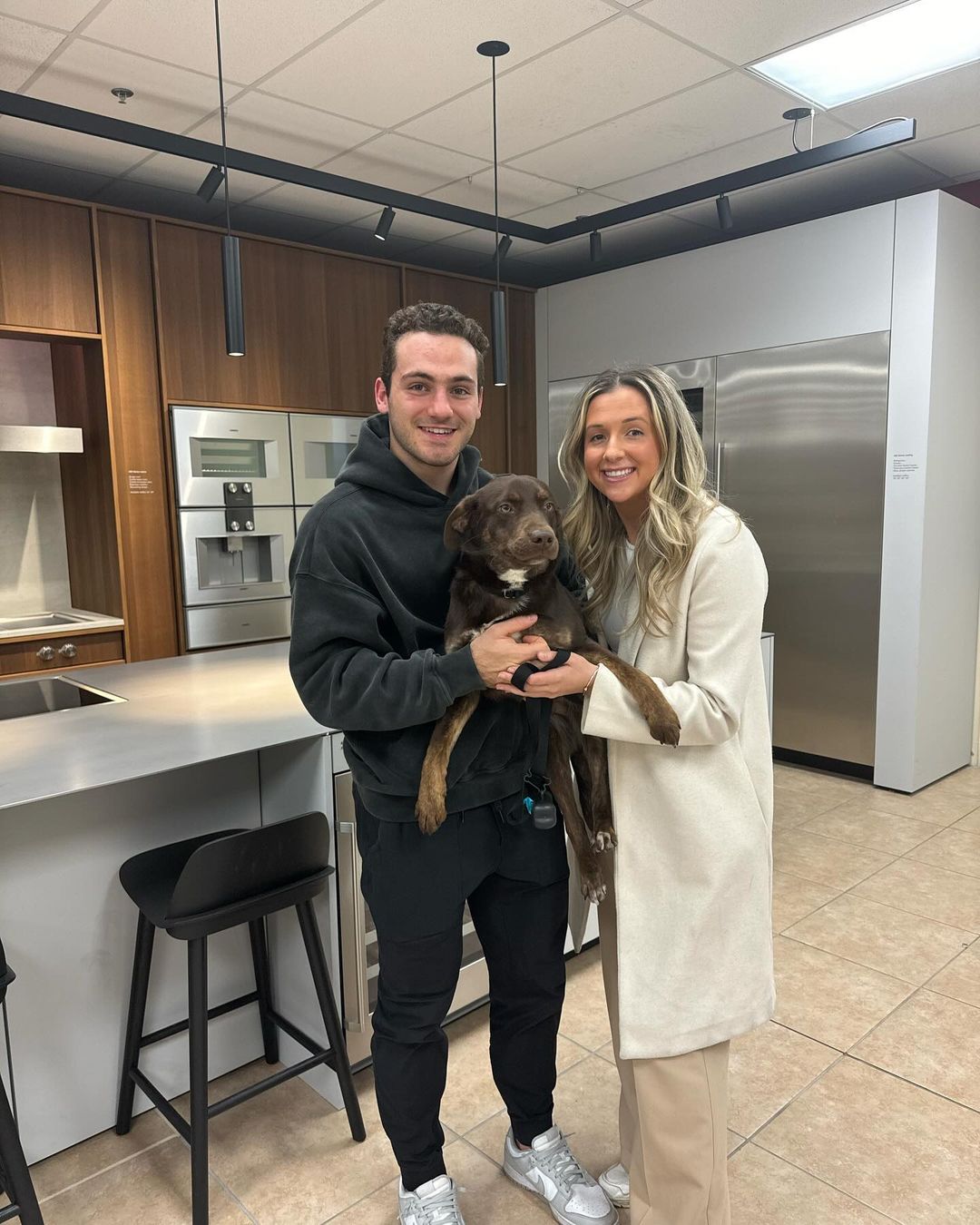 couple holding a dog