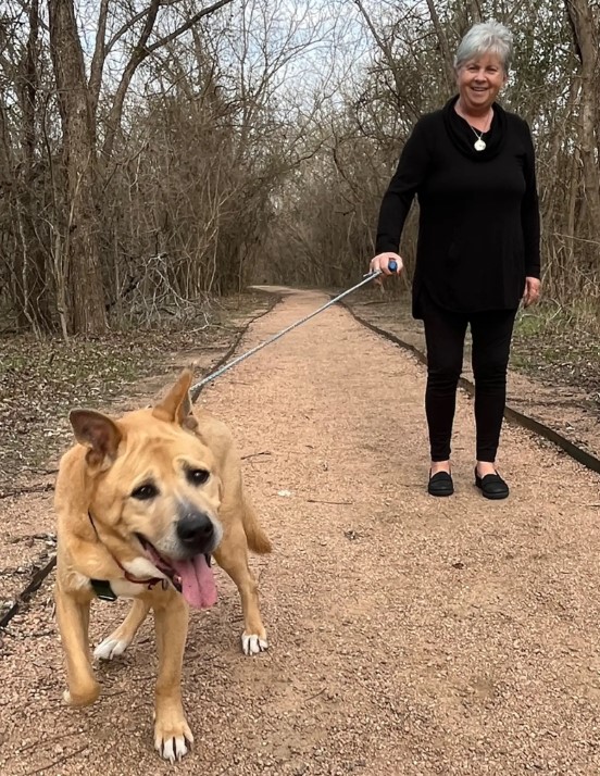 senior woman walking with dog