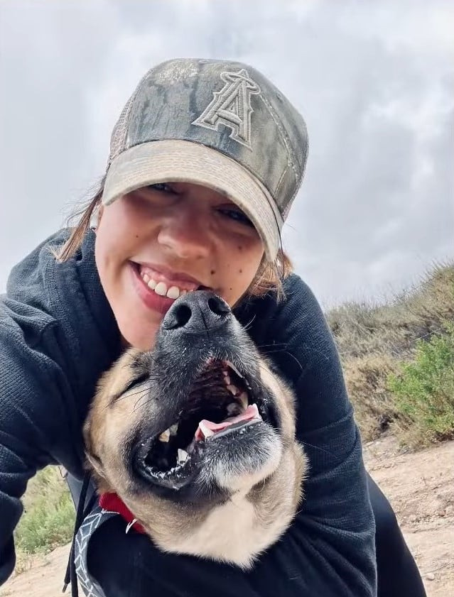 woman with hat and happy dog