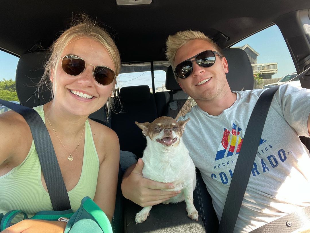 young couple with chihuahua in the car
