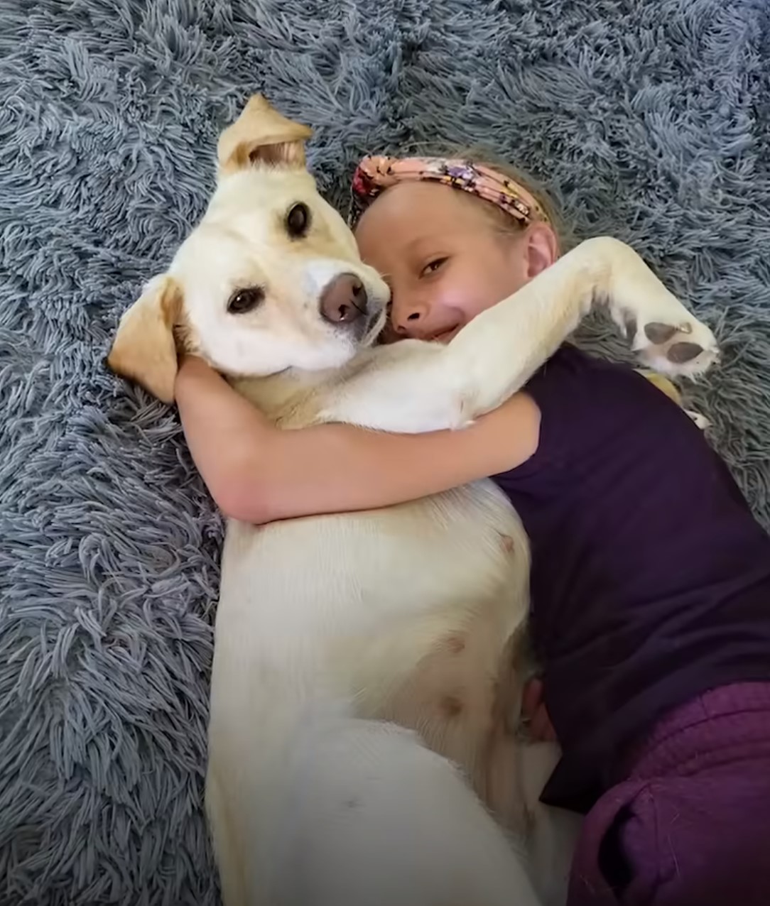 little girl hugging the puppy