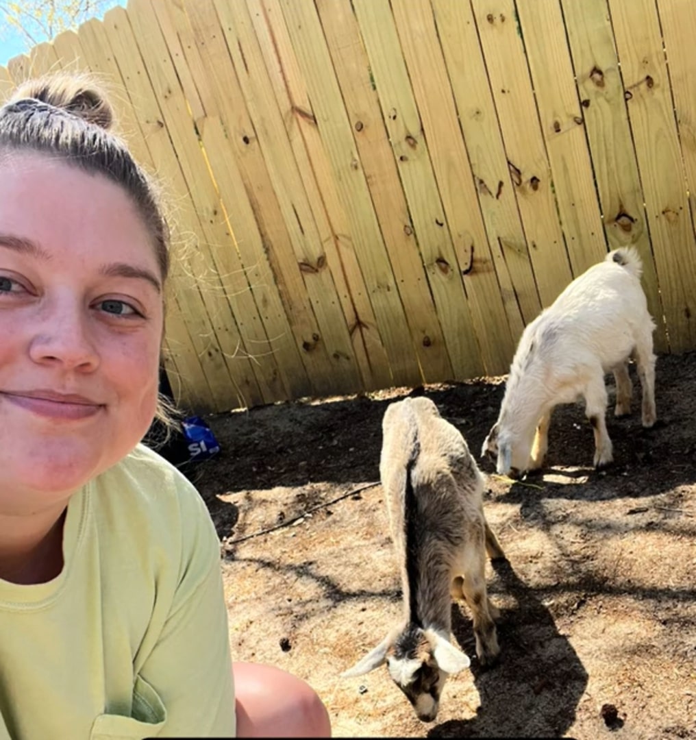 woman and two goats