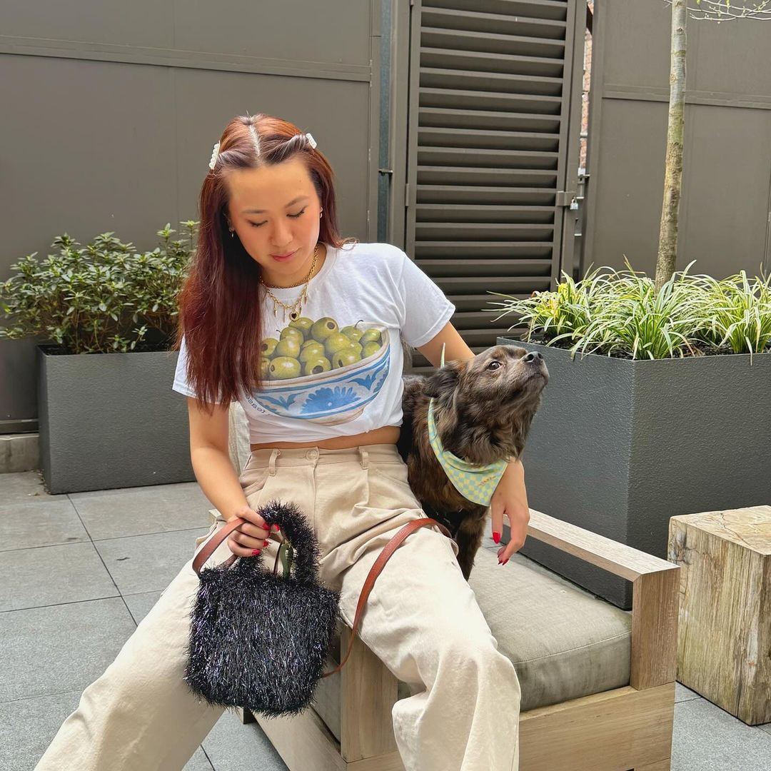 woman sitting next to dog