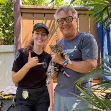 a man and a woman take a picture with a machete