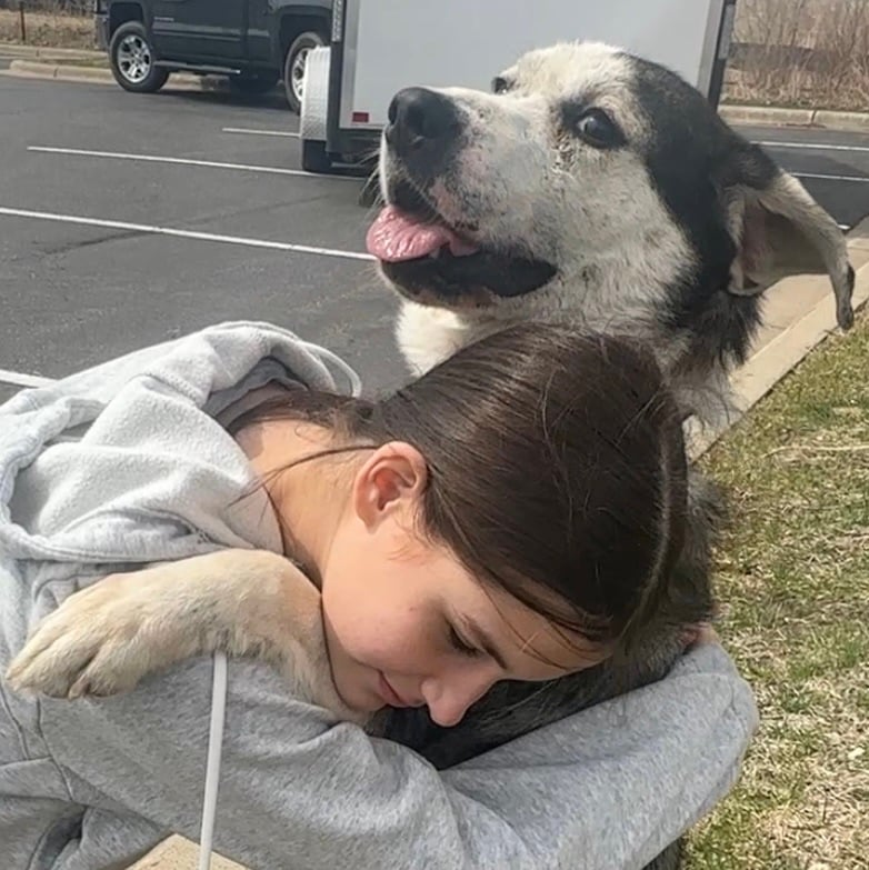 girl hugging a sweet dog