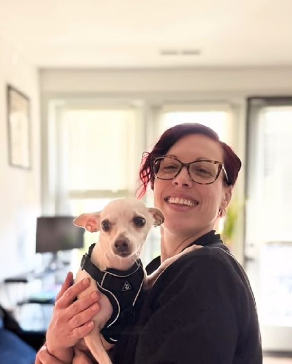 woman holding a tiny dog