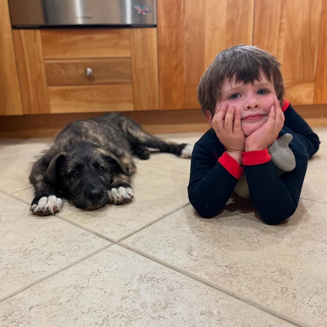 kid and dog laying down