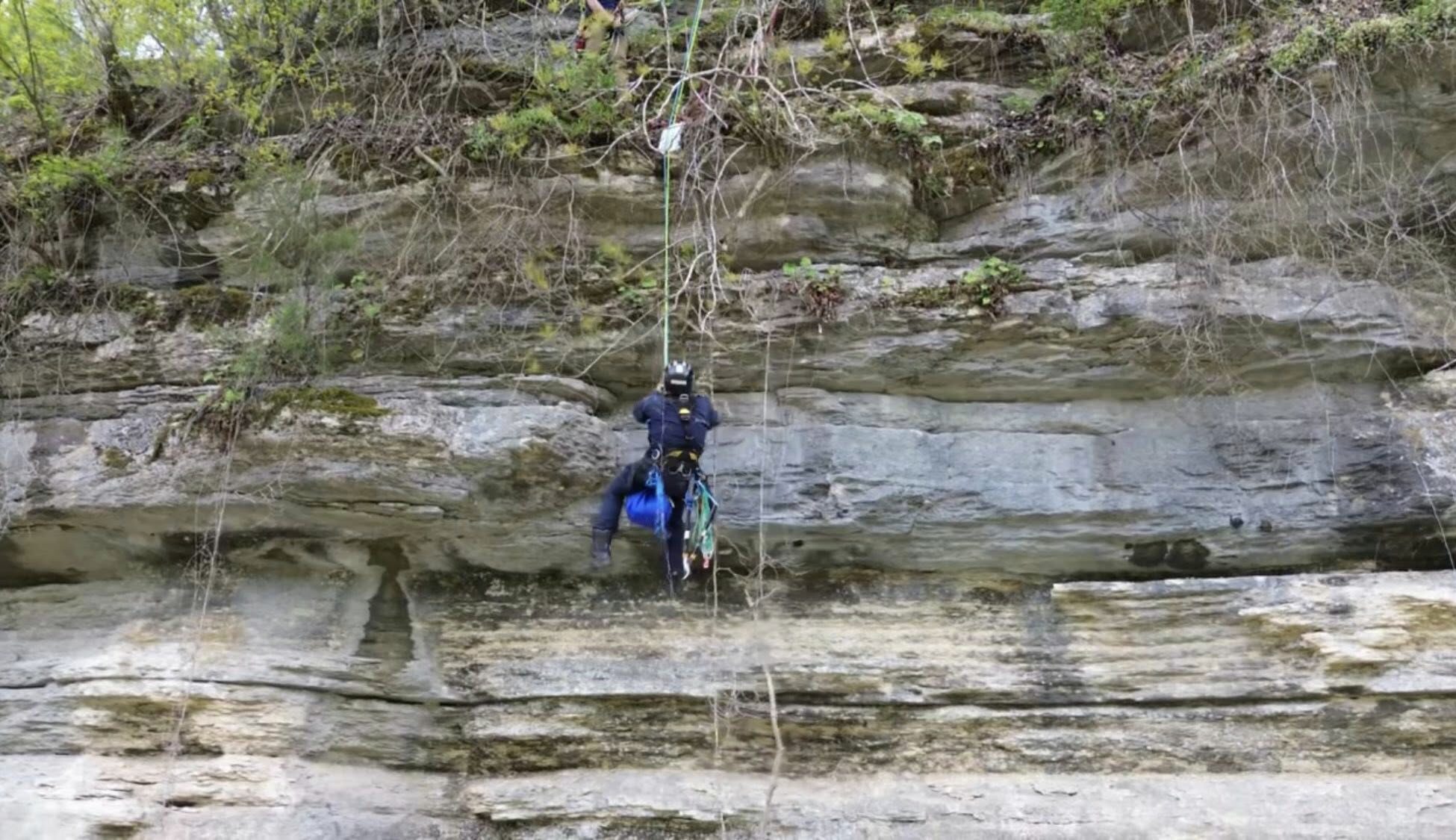 man climbing a cliff