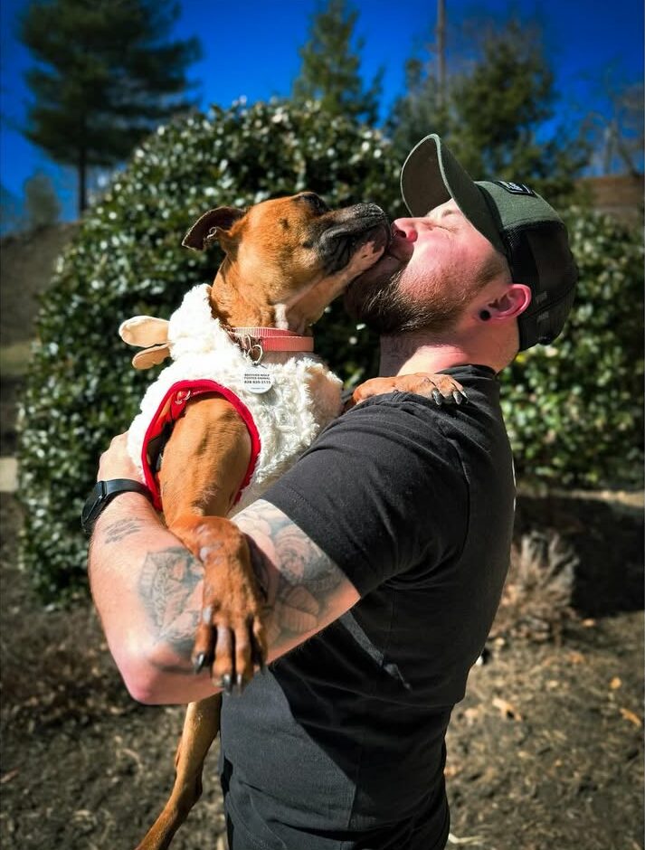 man holding a beautiful dog