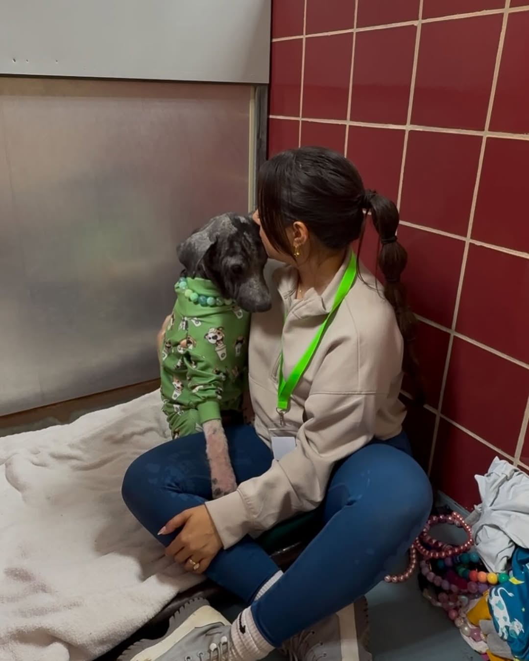 woman kissing a hairless dog