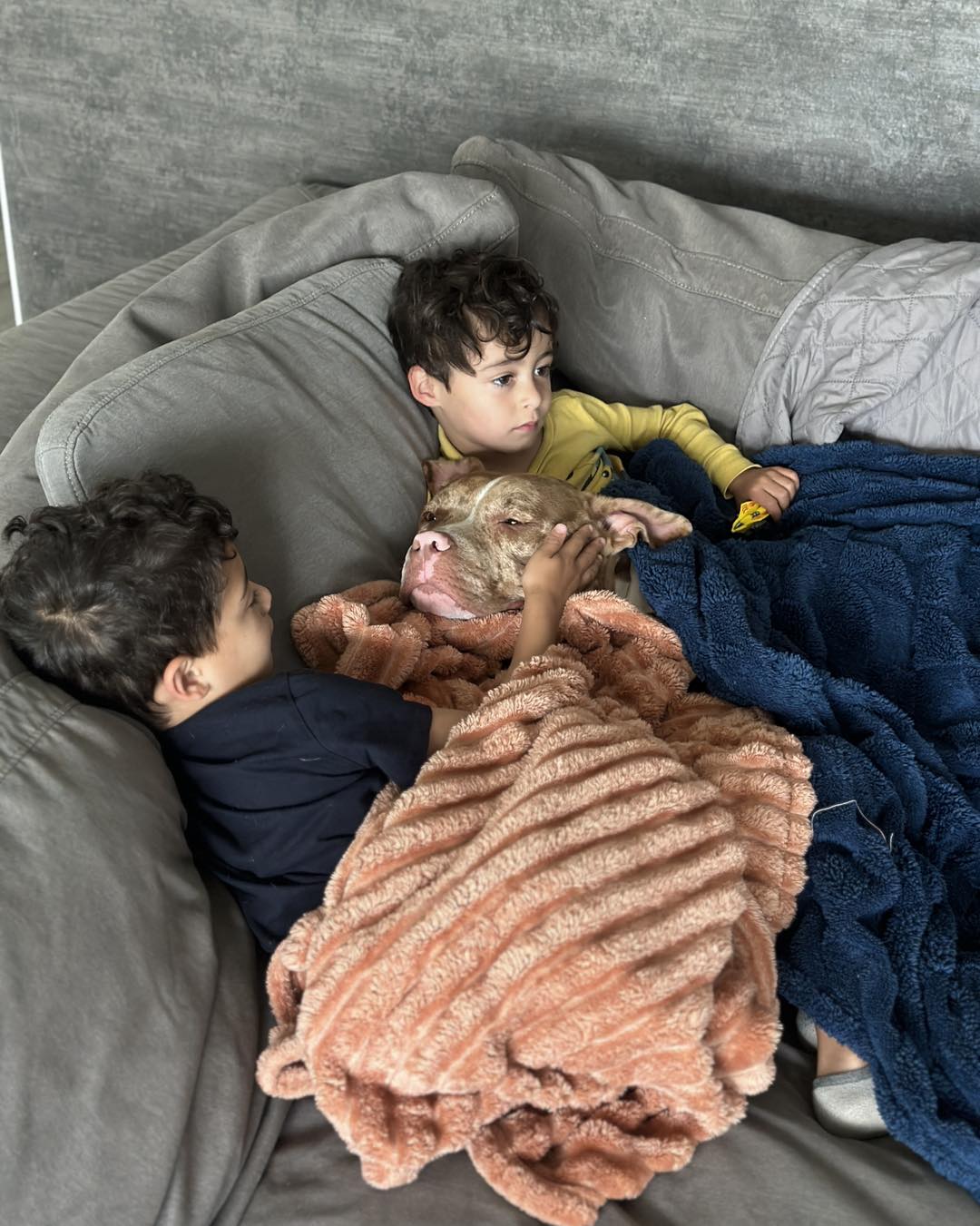 kids and dog laying together