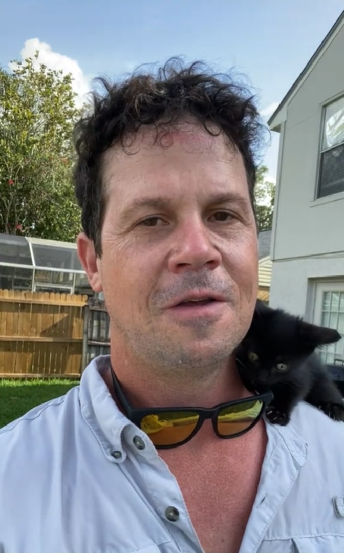 man and kitten on shoulder
