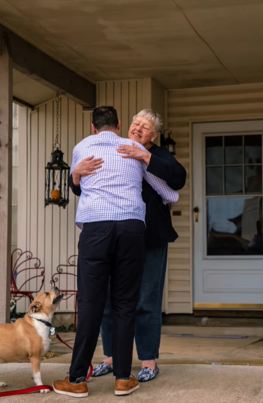 man hugging an old woman