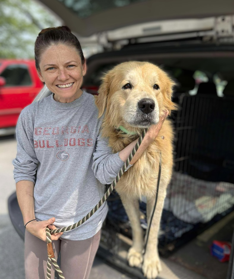 woman and dog in trunk