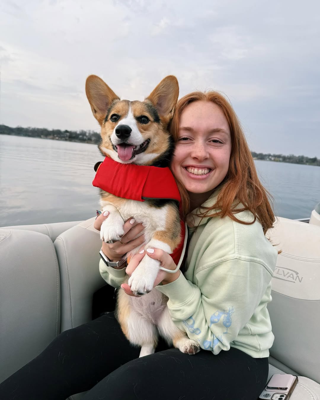 woman and dog on boat
