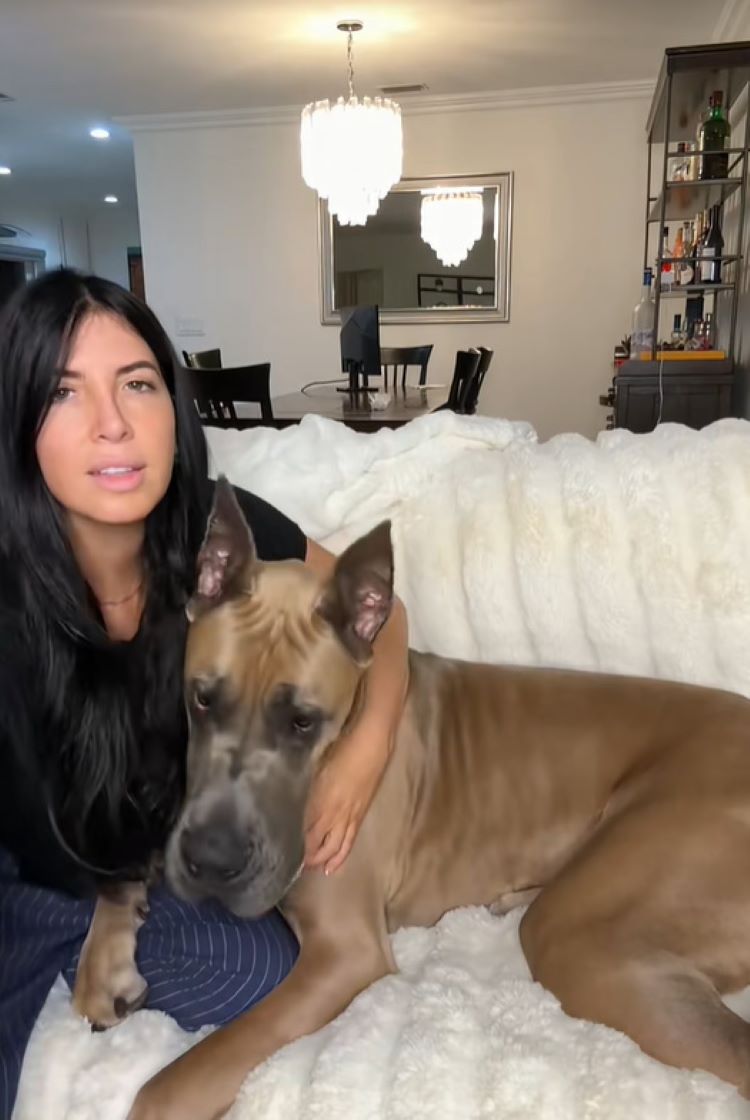 woman and dog sitting on couch