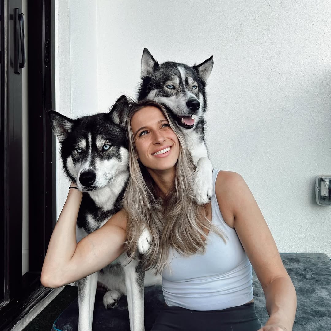 woman and two huskies